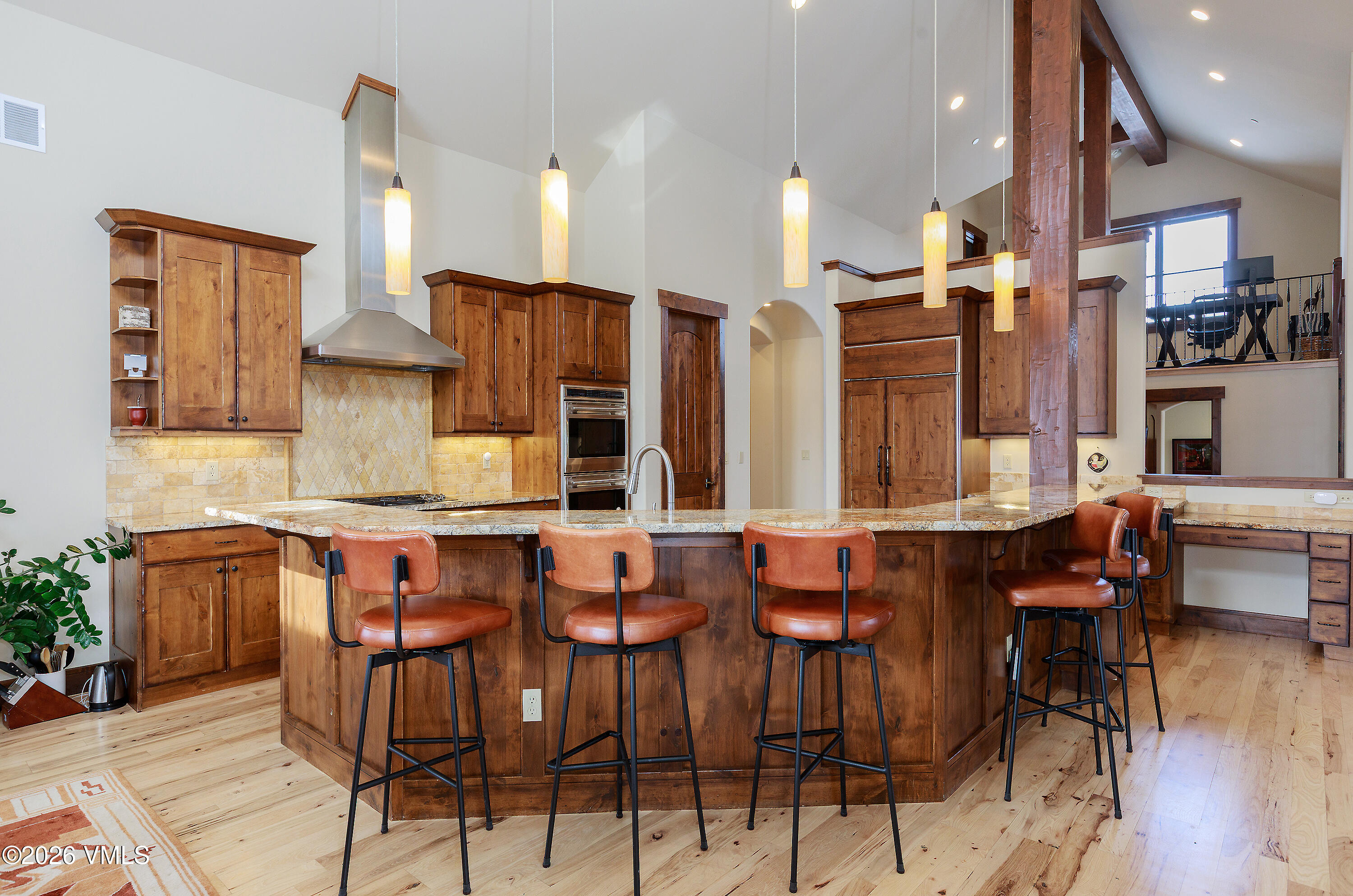 2753 East Haystacker Drive Eagle, CO 81631 - Photo 12 of 41 a dining area with stainless steel appliances kitchen island granite countertop a table and chairs