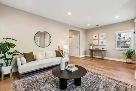 a living room with furniture a rug and a large window