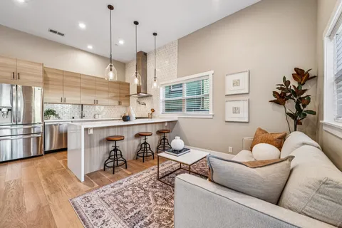 a living room with furniture and kitchen view