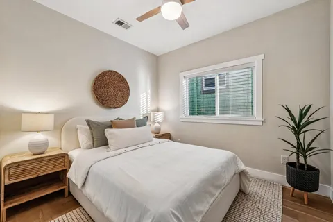 a bedroom with a bed and a potted plant