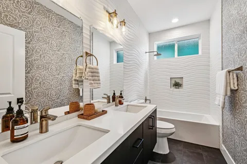 a bathroom with a sink double vanity and a toilet