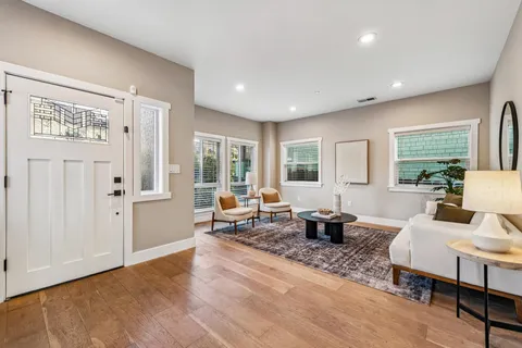 a living room with furniture and wooden floor