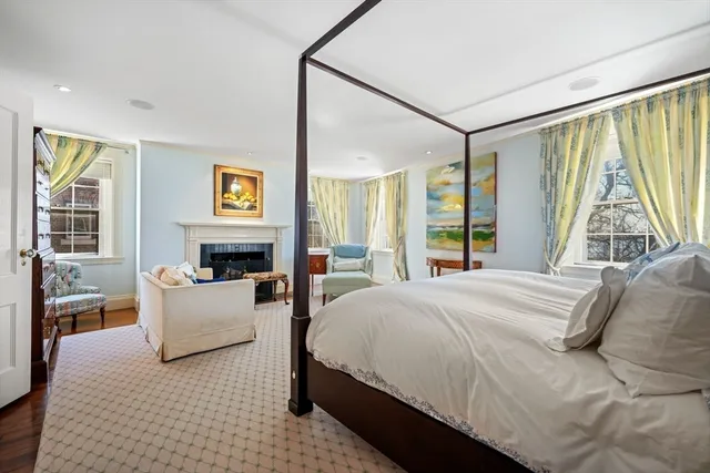 a bedroom with a large bed and a large window