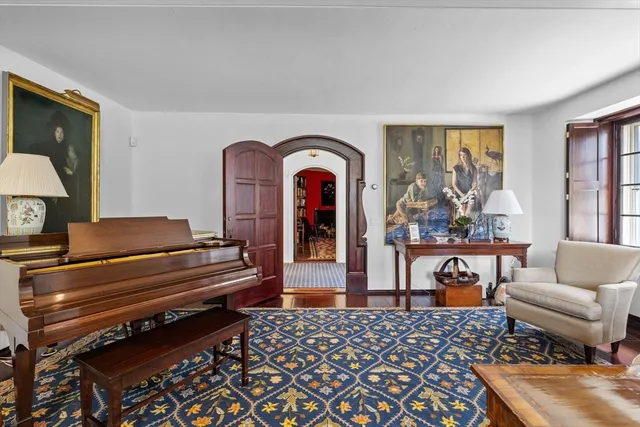 a living room with furniture a rug and a window