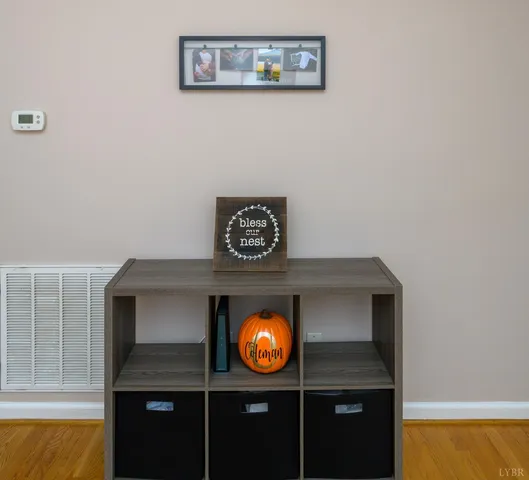 a kitchen with stainless steel appliances a sink cabinets and wooden floor
