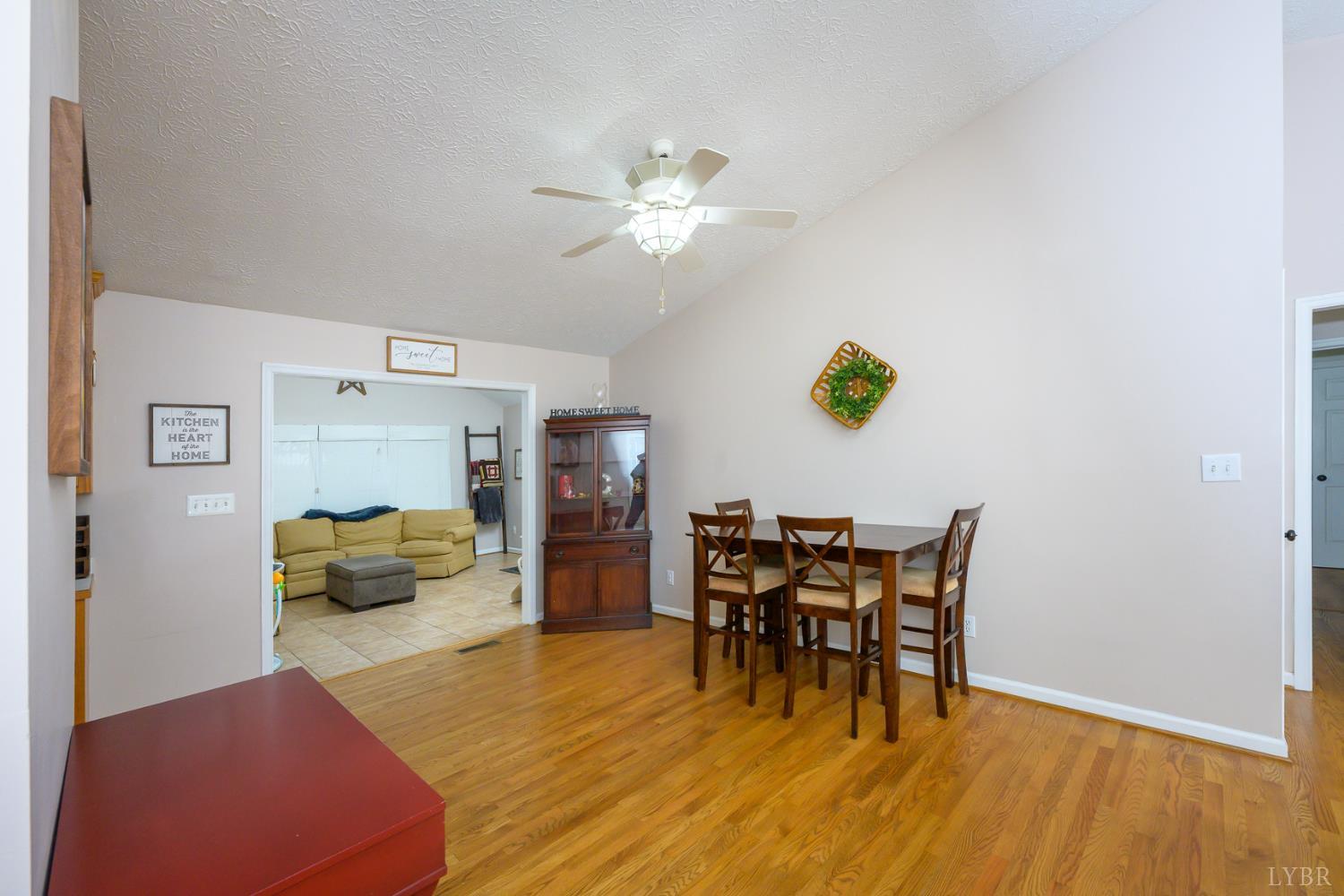 151 Wilderness Road Rustburg, VA 24588 - Photo 17 of 63 a dining room with furniture and wooden floor