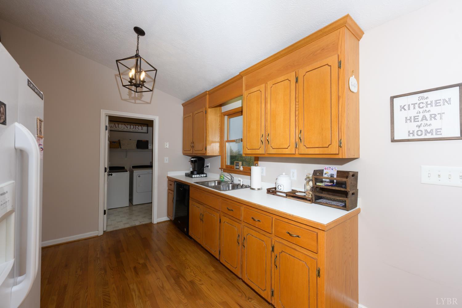 151 Wilderness Road Rustburg, VA 24588 - Photo 20 of 63 a kitchen with stainless steel appliances a sink cabinets and wooden floor