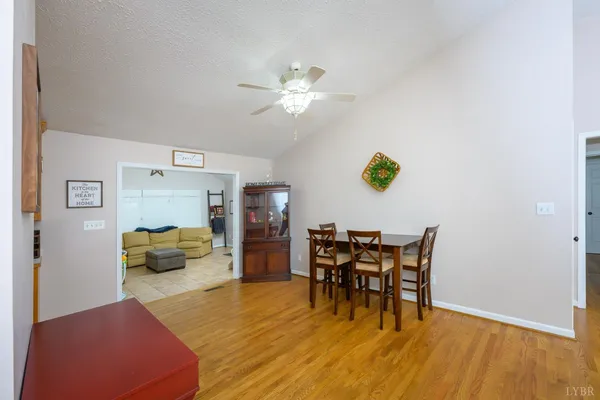 a view of a dining room with furniture and a chandelier