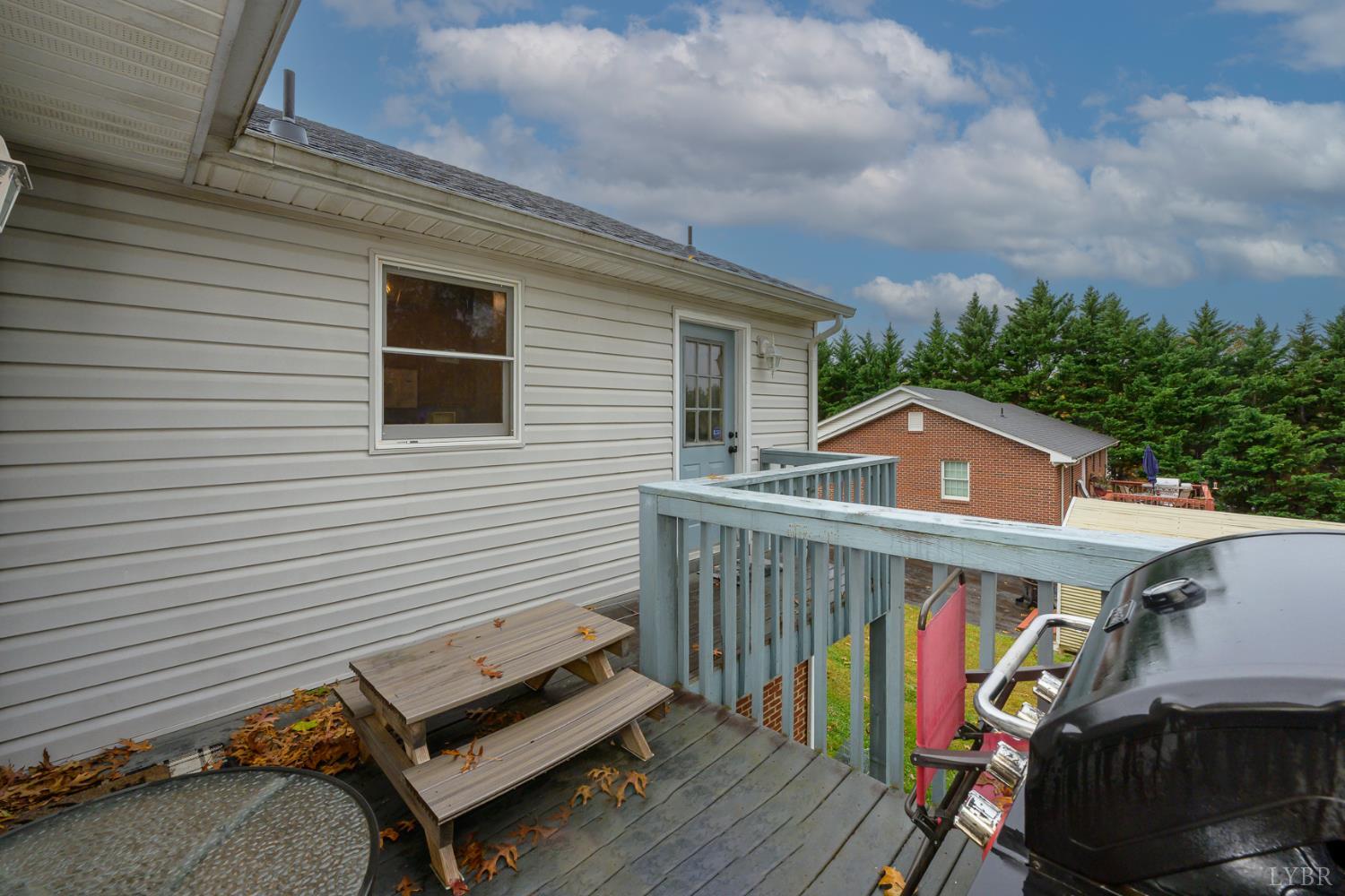 151 Wilderness Road Rustburg, VA 24588 - Photo 29 of 63 a view of a roof deck with wooden floor and fence