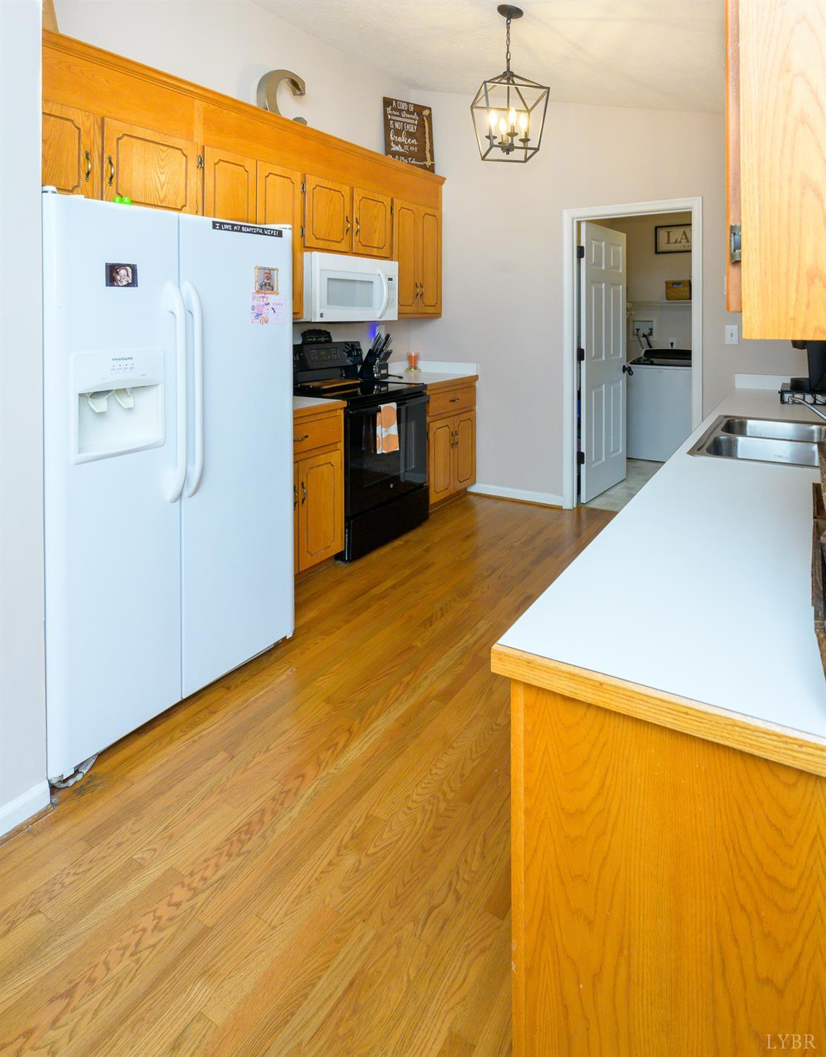 151 Wilderness Road Rustburg, VA 24588 - Photo 4 of 63 a kitchen with stainless steel appliances a refrigerator and a stove top oven