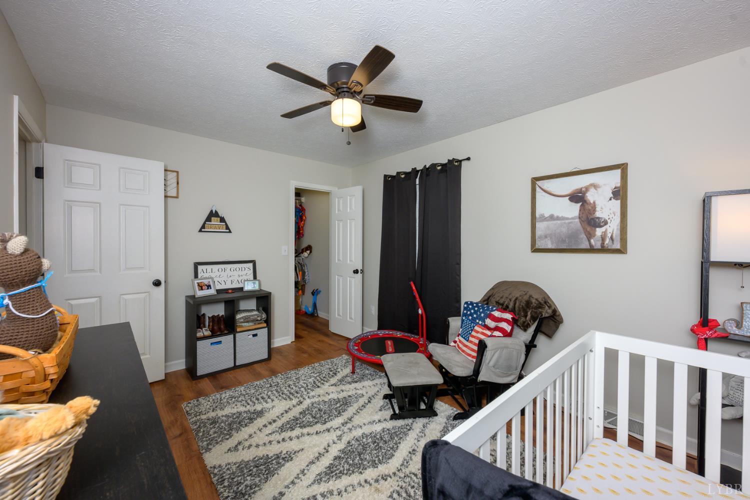151 Wilderness Road Rustburg, VA 24588 - Photo 41 of 63 a living room with furniture and baby crib
