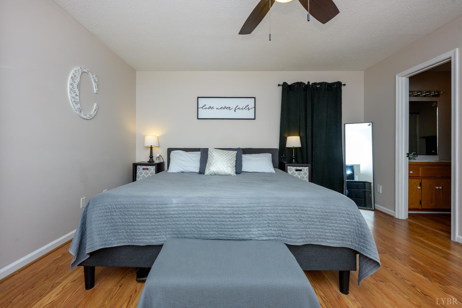 151 Wilderness Road Rustburg, VA 24588 - Photo 45 of 63 a bedroom with a bed and wooden floor