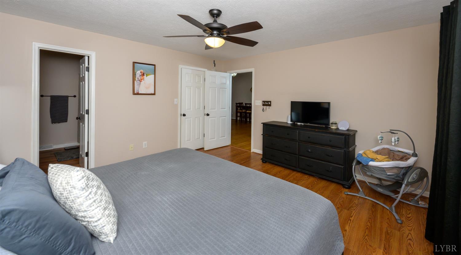 151 Wilderness Road Rustburg, VA 24588 - Photo 46 of 63 a bedroom with a bed and a chandelier