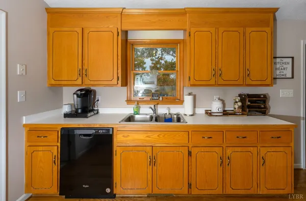 a kitchen with stainless steel appliances granite countertop a refrigerator a stove and a wooden floor