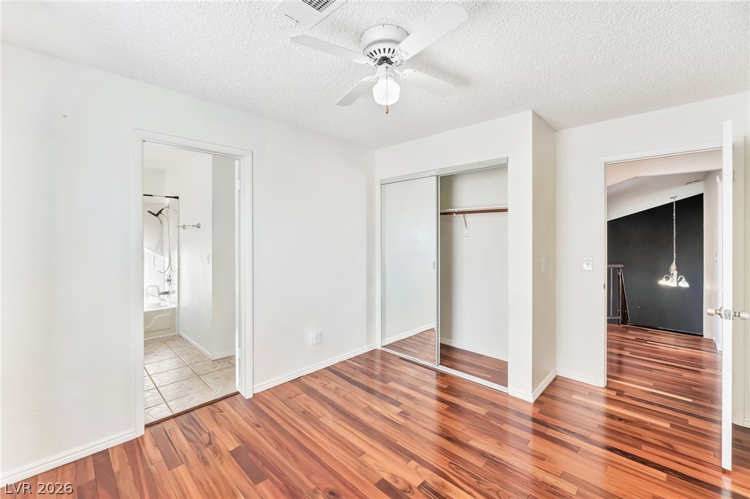 1402 Rim Fire Circle Henderson, NV 89014 - Photo 28 of 48 Gleaming wood floors and a mirrored closet define this light-filled room with clean white walls.