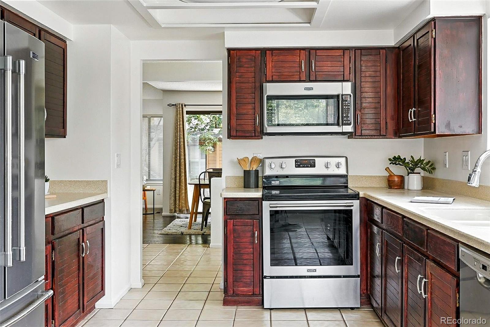 9400 East Iliff Avenue, Unit 321 Denver, CO 80231 - Photo 11 of 44 a kitchen with a stove and a sink