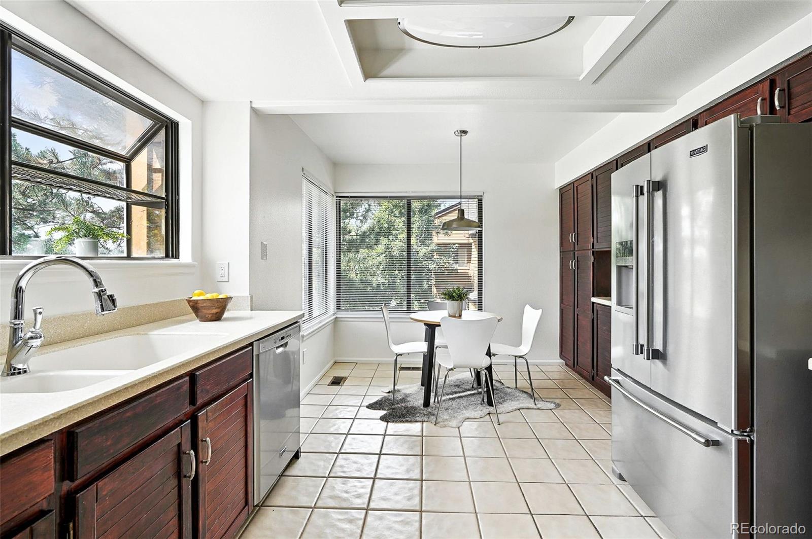 9400 East Iliff Avenue, Unit 321 Denver, CO 80231 - Photo 12 of 44 a kitchen with a sink appliances and a counter top space