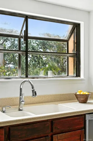 a kitchen with stainless steel appliances a refrigerator a table and chairs