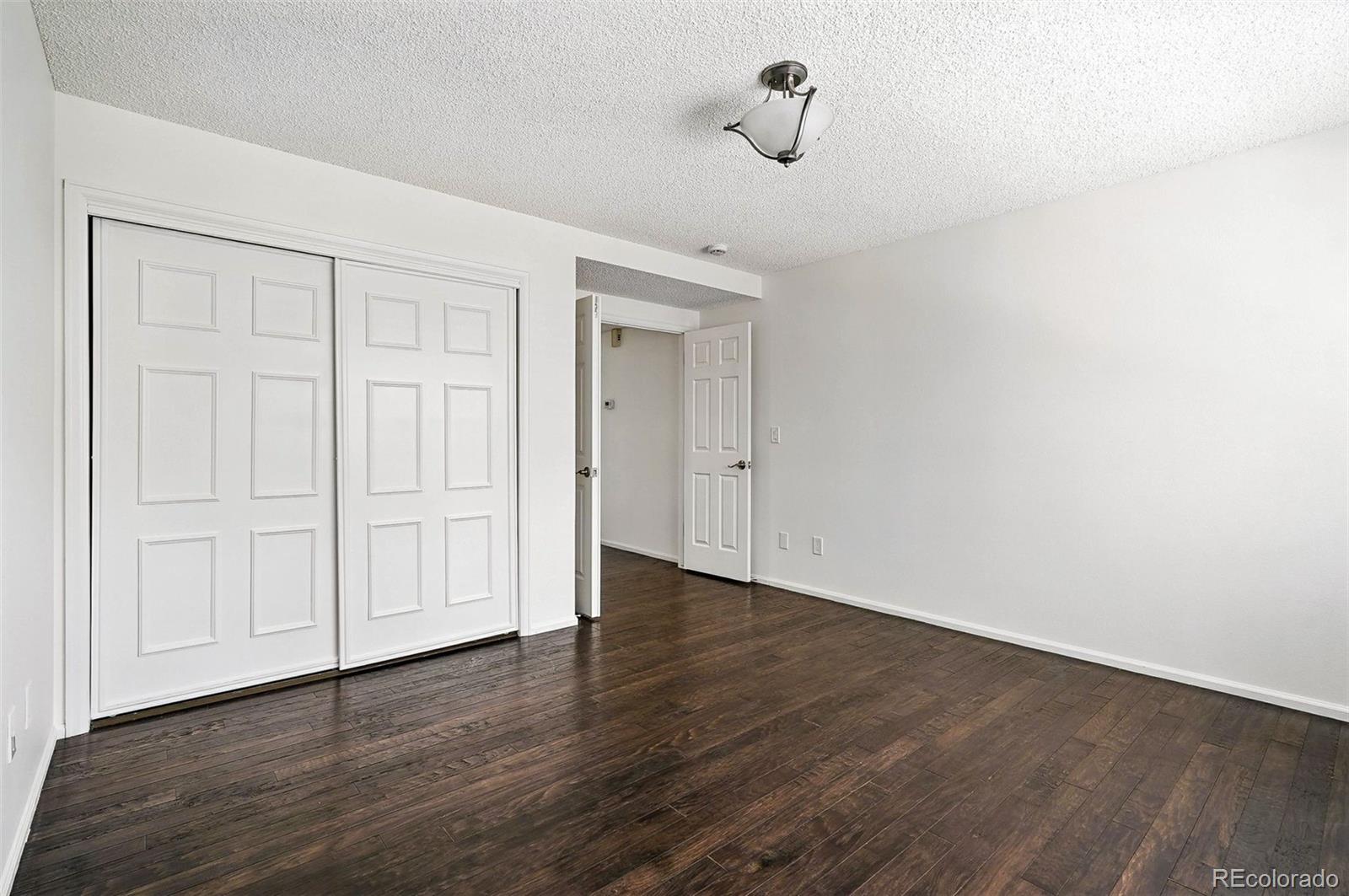 9400 East Iliff Avenue, Unit 321 Denver, CO 80231 - Photo 18 of 44 a view of an empty room with wooden floor