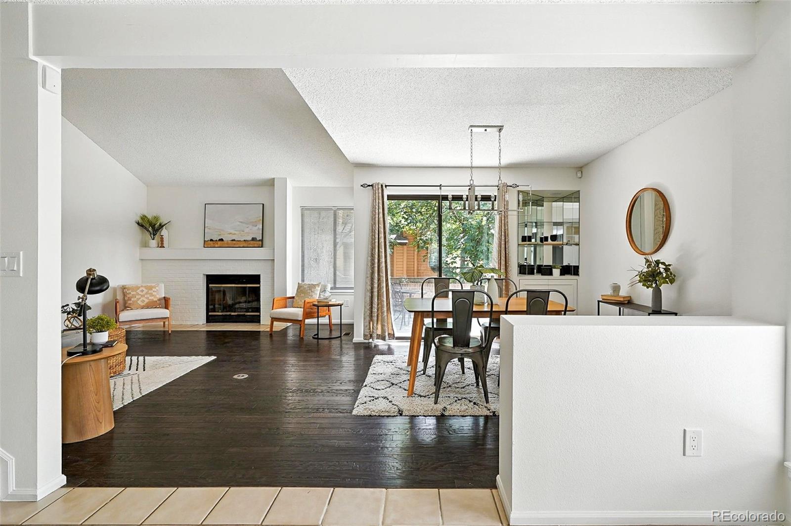 9400 East Iliff Avenue, Unit 321 Denver, CO 80231 - Photo 2 of 44 a living room with furniture a fireplace and a table