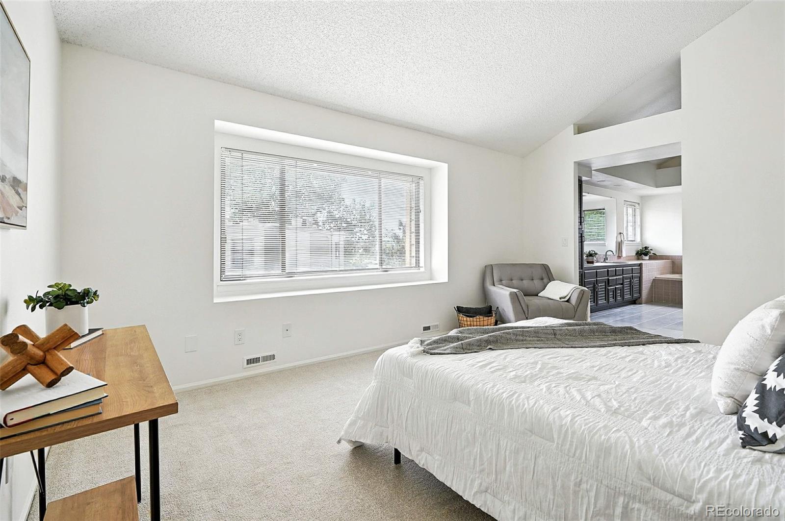 9400 East Iliff Avenue, Unit 321 Denver, CO 80231 - Photo 23 of 44 a bedroom with a bed and a table in it