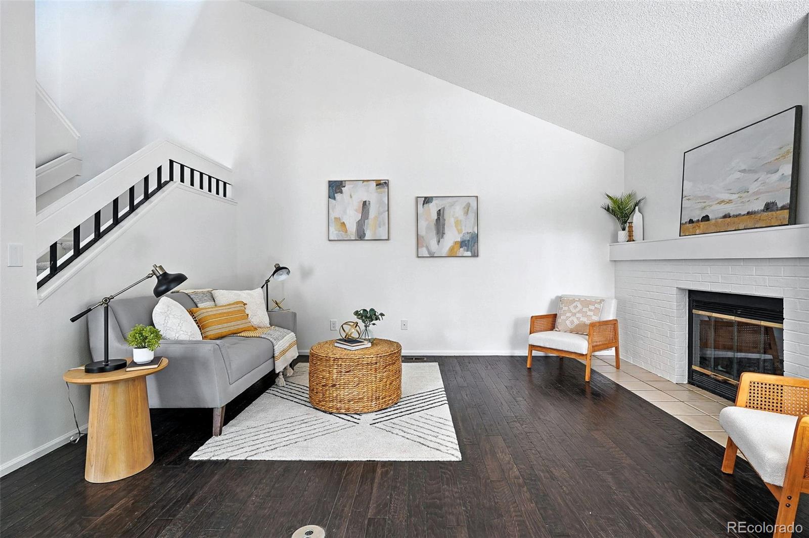 9400 East Iliff Avenue, Unit 321 Denver, CO 80231 - Photo 3 of 44 a living room with furniture and a fireplace