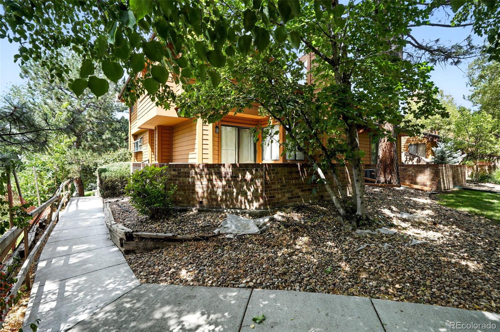 9400 East Iliff Avenue, Unit 321 Denver, CO 80231 - Photo 35 of 44 a front view of a house with a yard