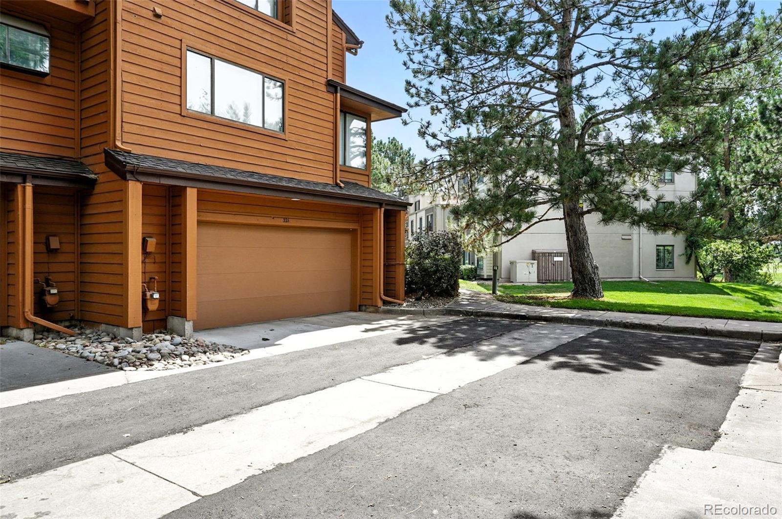 9400 East Iliff Avenue, Unit 321 Denver, CO 80231 - Photo 38 of 44 a front view of a house with a yard and garage