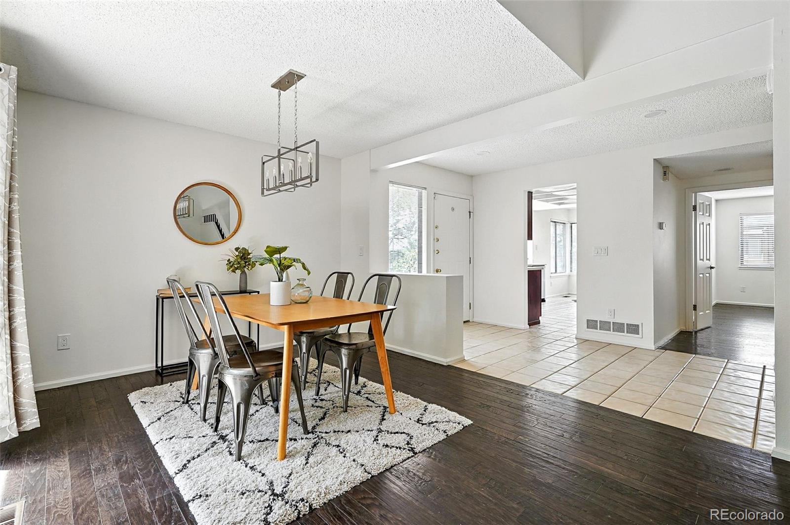 9400 East Iliff Avenue, Unit 321 Denver, CO 80231 - Photo 9 of 44 a view of a dining room with furniture window and wooden floor