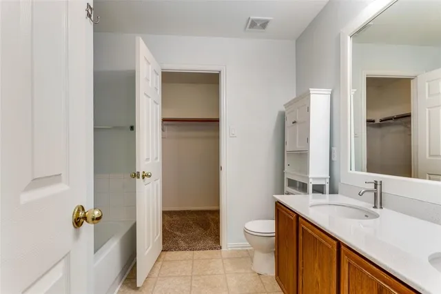 an empty room with fan and entrance