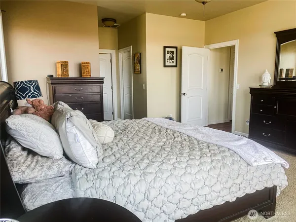 a bedroom with a bed and a dresser