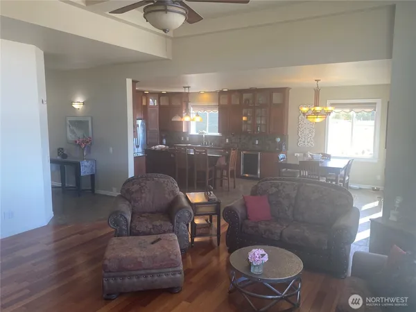 a living room with furniture and a chandelier