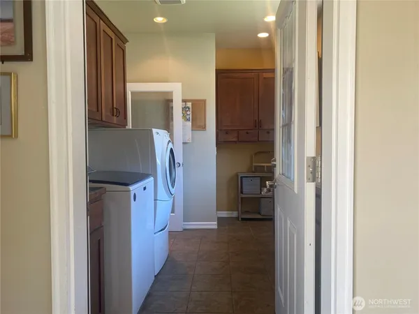 a view of a hallway with a livingroom and a bathroom