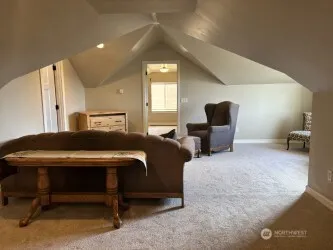 a living room with furniture and a chair