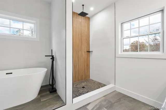 an empty room with bed and ceiling fan