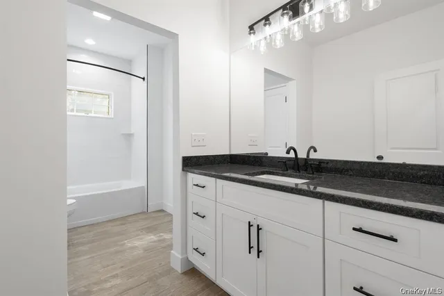 an empty room with closet and windows