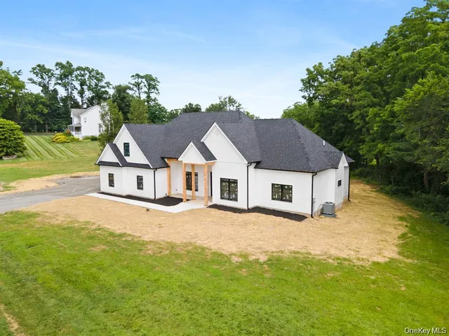 a view of a house with a yard and garage