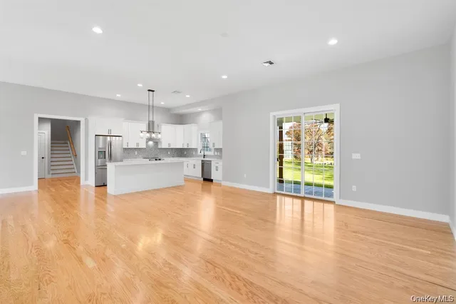 a kitchen with stainless steel appliances a white stove top oven and a chandelier