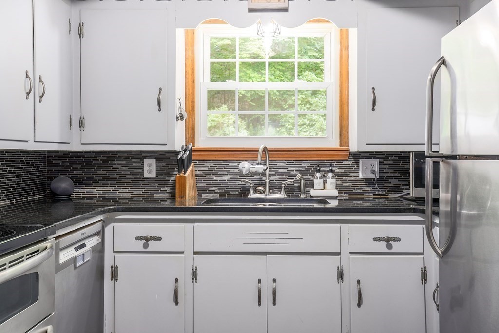 200 West Sutton Road Sutton, MA 01590 - Photo 14 of 33 a kitchen with stainless steel appliances granite countertop a sink and a granite counter tops