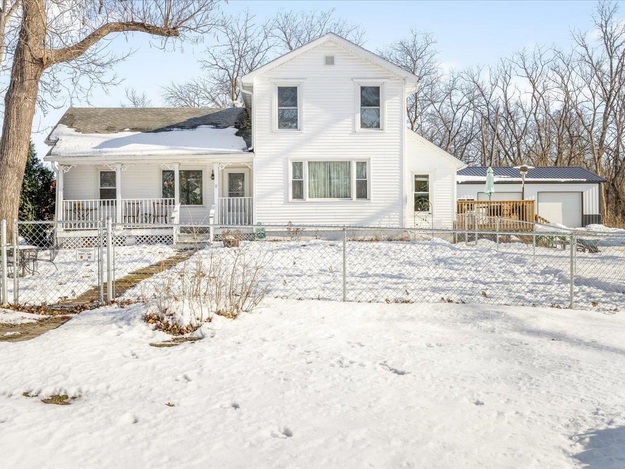 13005 Mitchell Street Shirland, IL 61079 - Photo 33 of 37 a front view of a house with a yard covered in snow