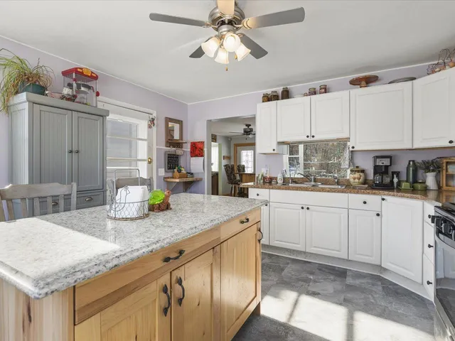 a kitchen with a table chairs refrigerator and cabinets