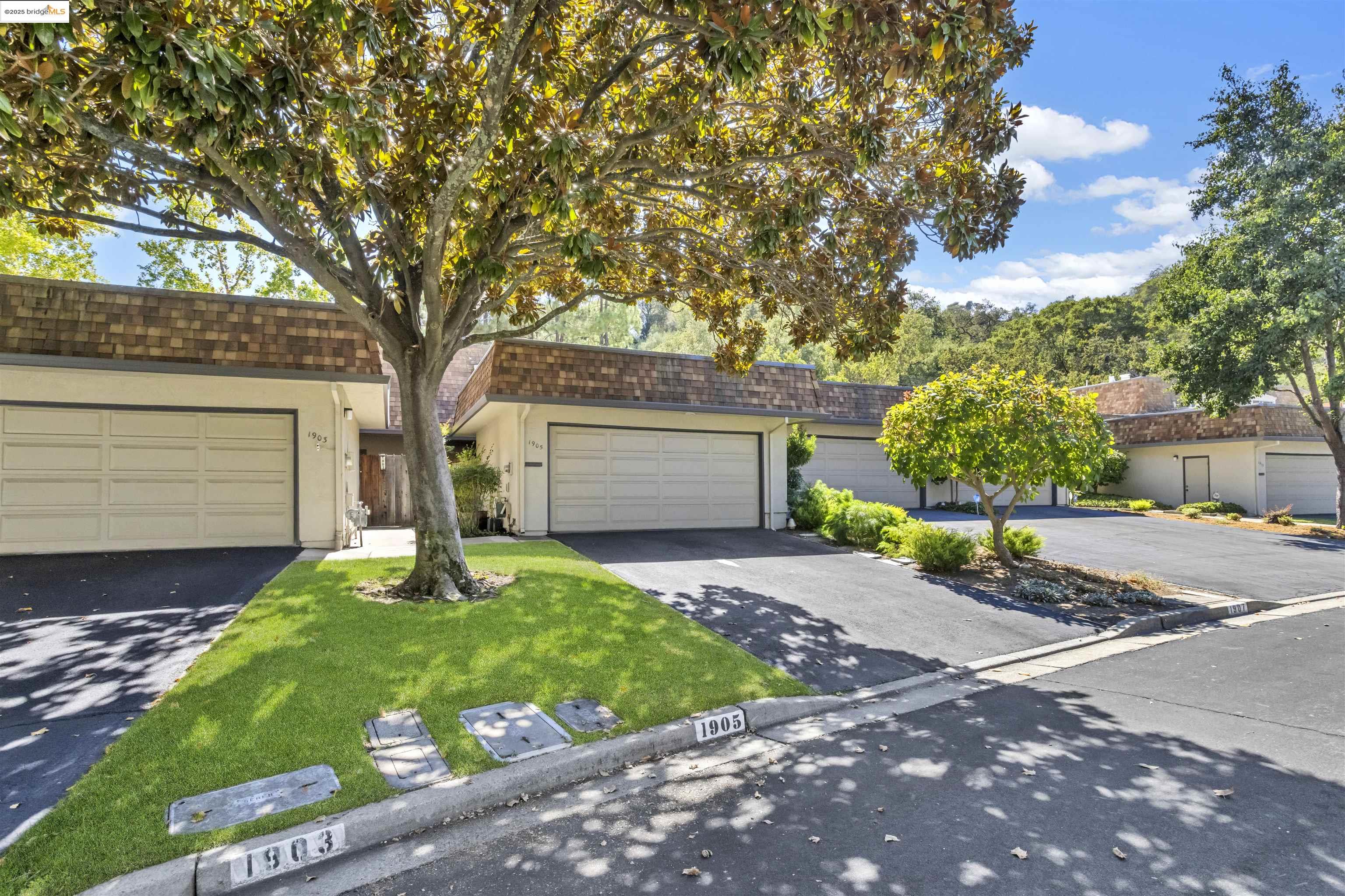 1905 Cannon Place Walnut Creek, CA 94597 - Photo 31 of 40 a front view of a house with a yard and garage