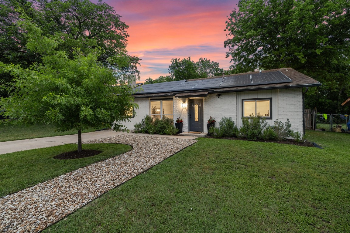 2218 Palmera Cove Austin, TX 78744 - Photo 1 of 1 a front view of a house with a garden