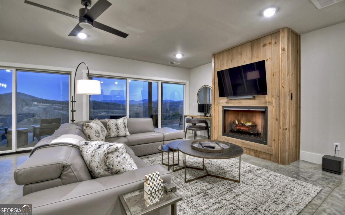 375 Blue Berry Ridge, Unit 2B Morganton, GA 30560 - Photo 19 of 61 a living room with furniture flat screen tv and a fireplace
