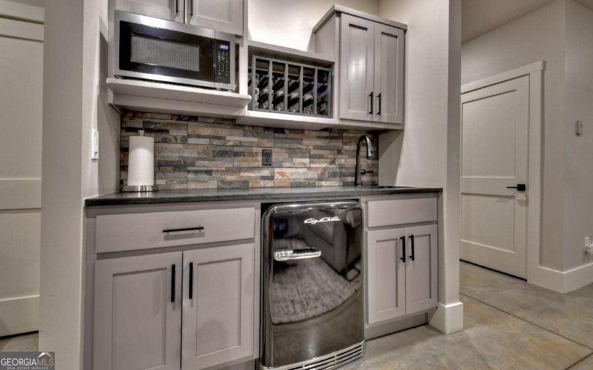 375 Blue Berry Ridge, Unit 2B Morganton, GA 30560 - Photo 23 of 61 a kitchen with stainless steel appliances granite countertop a stove and a microwave