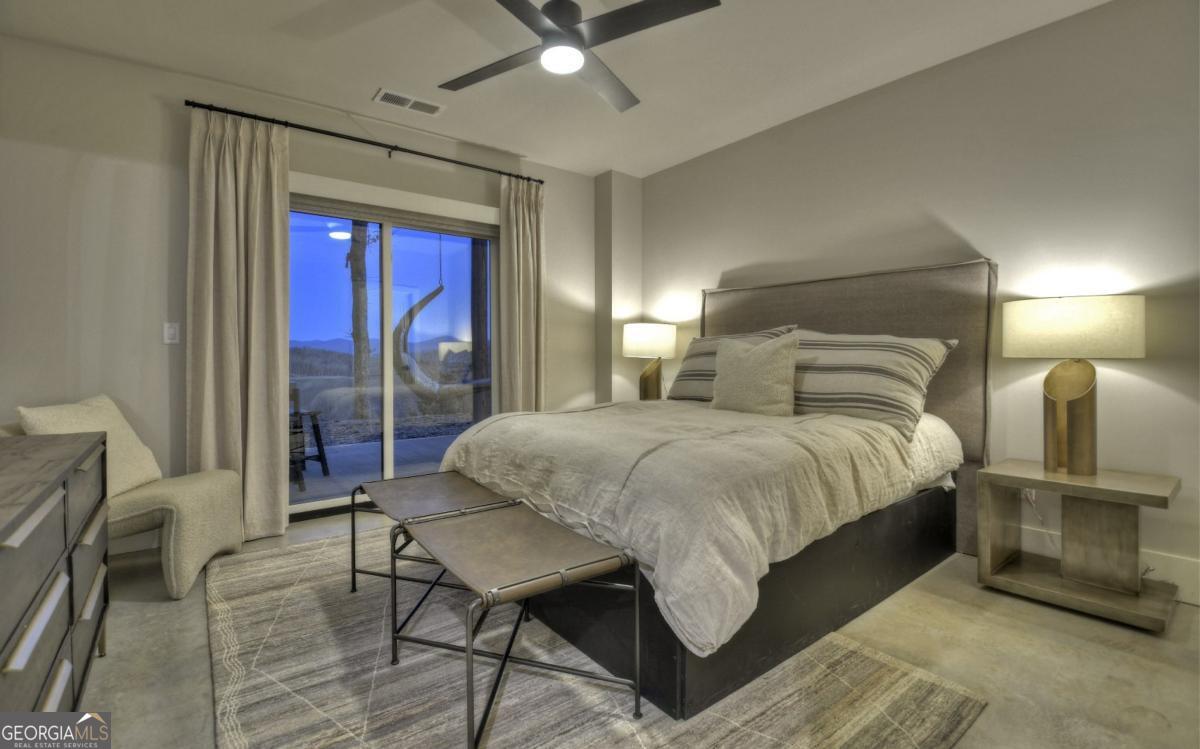 375 Blue Berry Ridge, Unit 2B Morganton, GA 30560 - Photo 26 of 61 a bedroom with a large bed and a chandelier