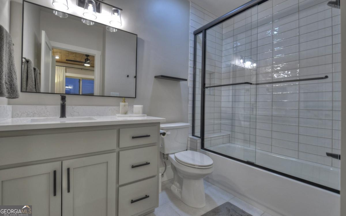 375 Blue Berry Ridge, Unit 2B Morganton, GA 30560 - Photo 27 of 61 a bathroom with a sink a toilet and shower