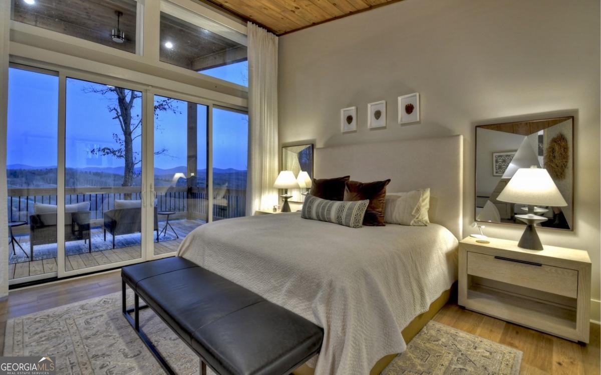 375 Blue Berry Ridge, Unit 2B Morganton, GA 30560 - Photo 9 of 61 a bedroom with a bed and lamp