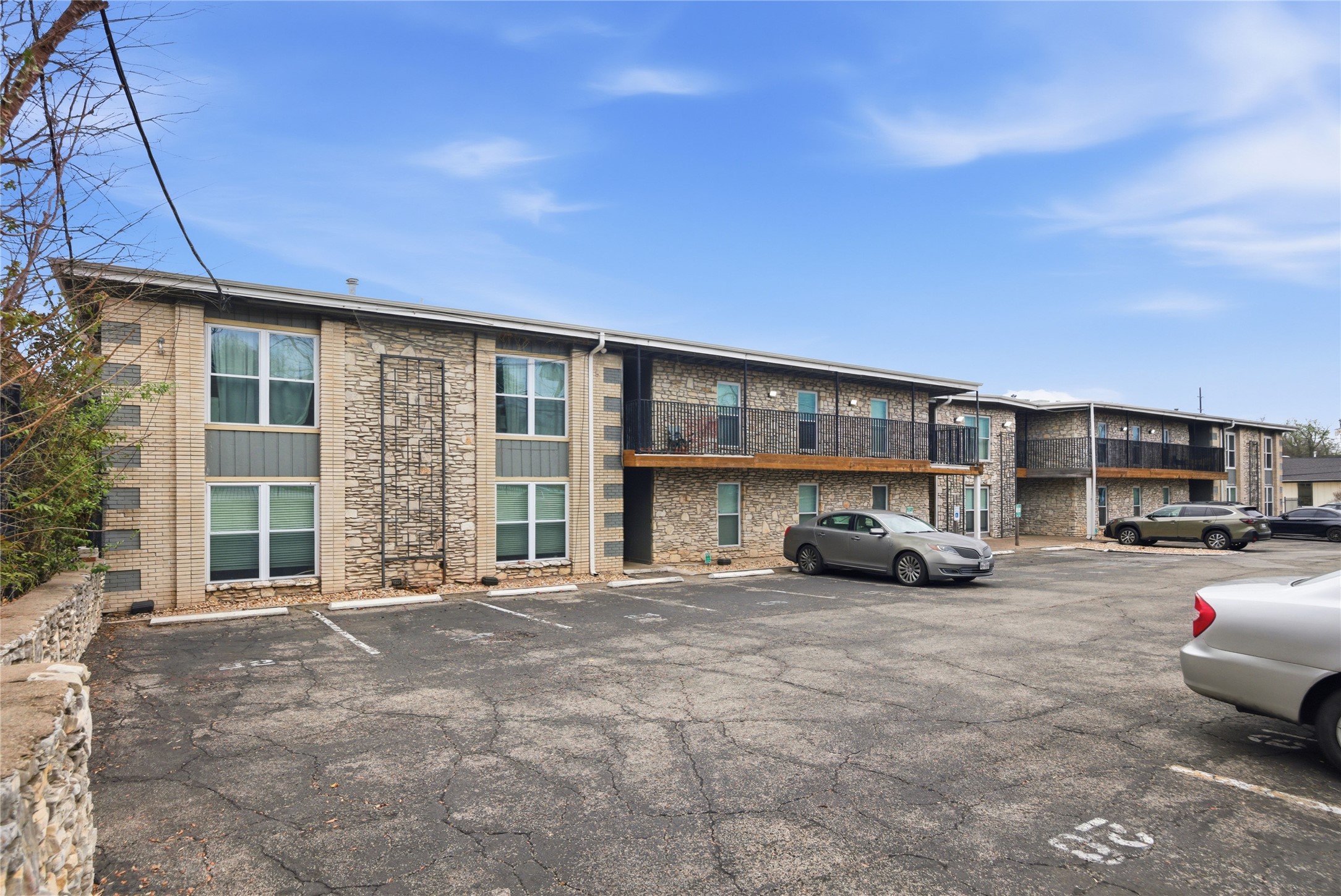 2401 Manor Road, Unit 232 Austin, TX 78722 - Photo 28 of 32 View of building exterior with uncovered parking