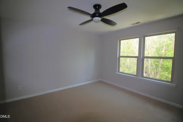 a view of room window and a ceiling fan